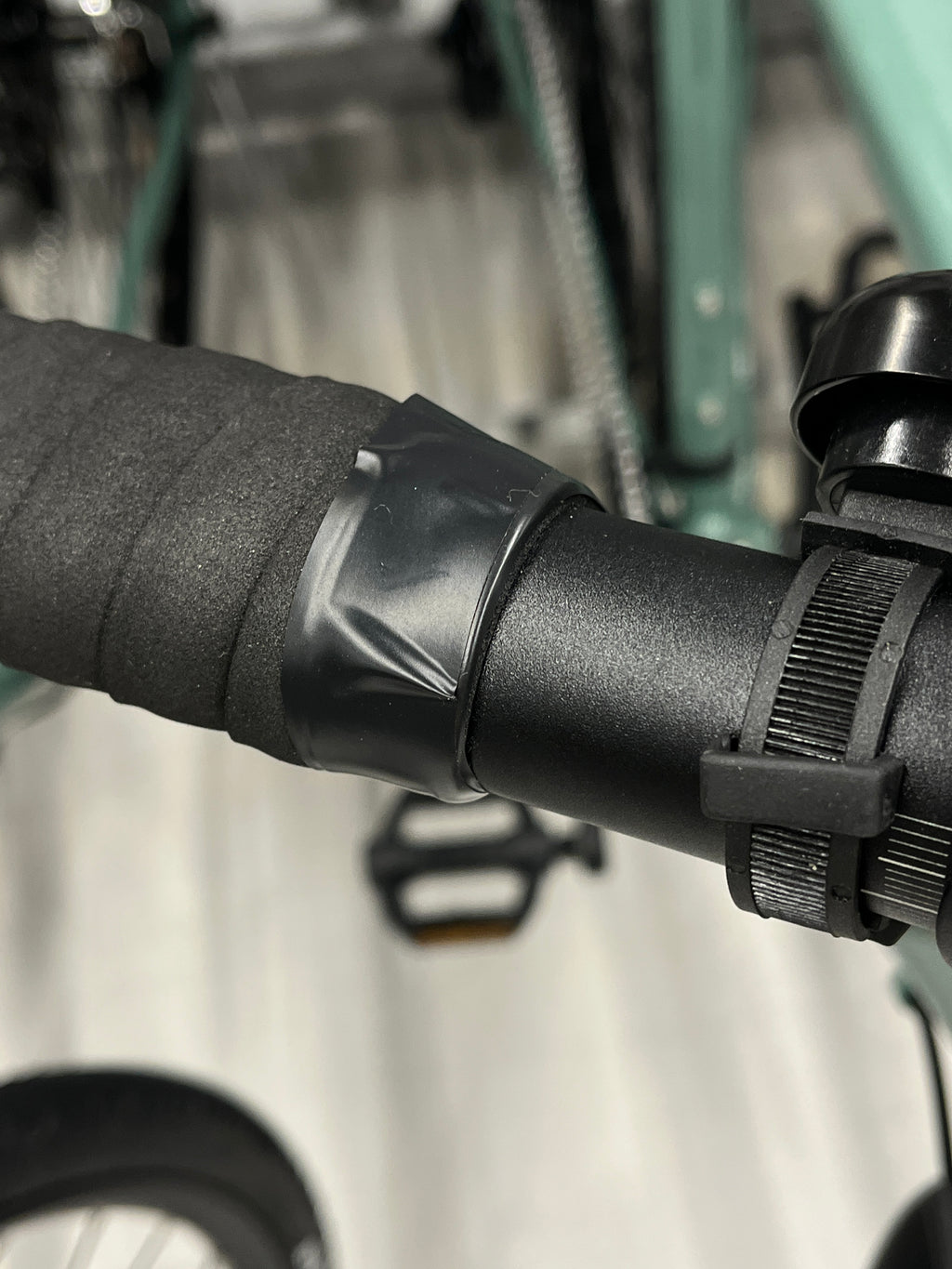 Electrical tape end lifting and creasing at the top of a bar wrap