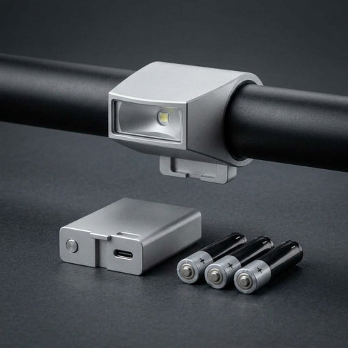 Low-Mount Crash-Safe MTB Headlight on a flat bar with its removable battery pack and three AAA batteries