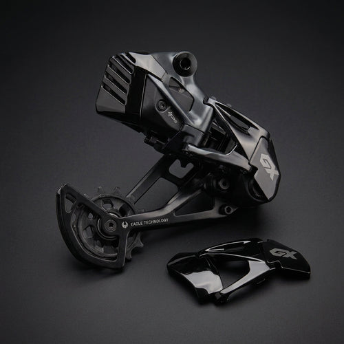SRAM Derailleur Cover in black polished next to a SRAM GX Eagle derailleur