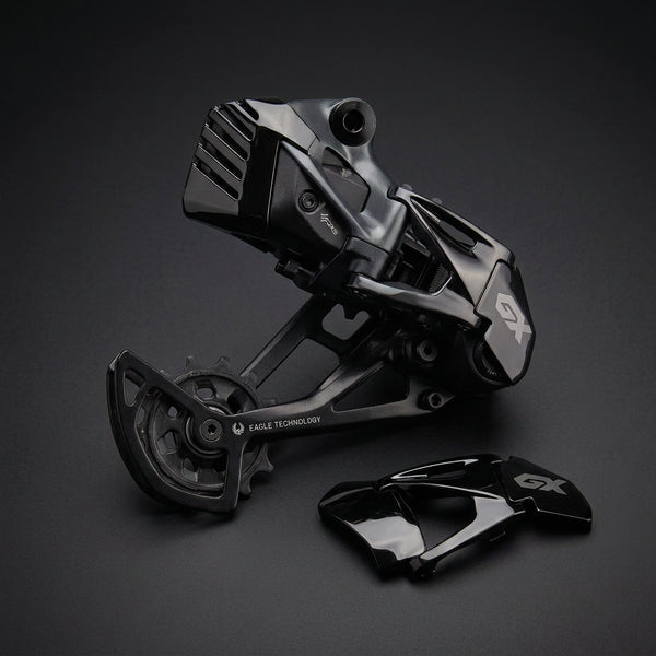 SRAM Derailleur Cover in black polished next to a SRAM GX Eagle derailleur