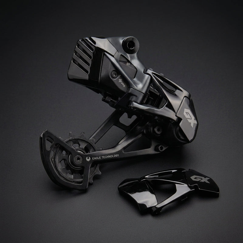 SRAM Derailleur Cover in black polished next to a SRAM GX Eagle derailleur