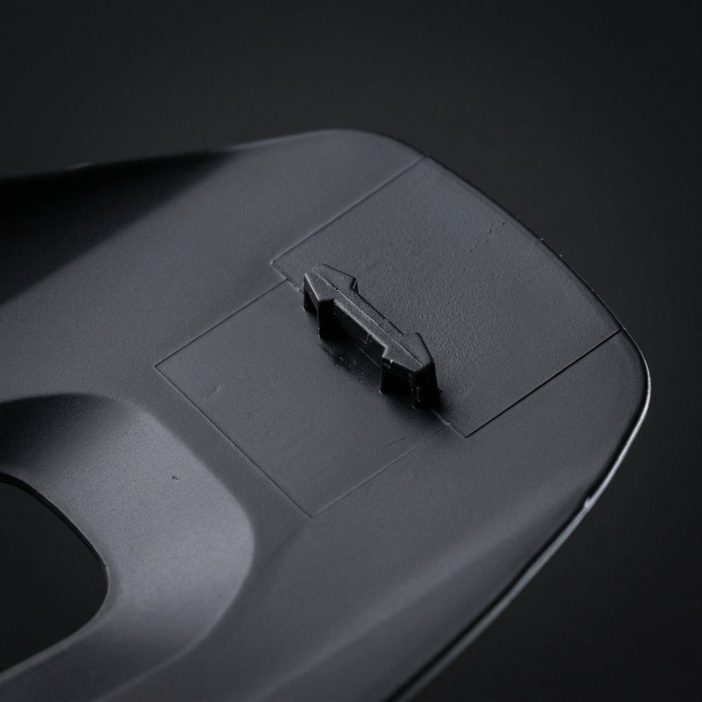 Breakaway Visor Pin mounted on the underside of a black helmet visor, close up