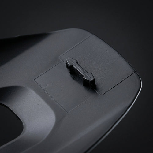 Breakaway Visor Pin mounted on the underside of a black helmet visor, close up