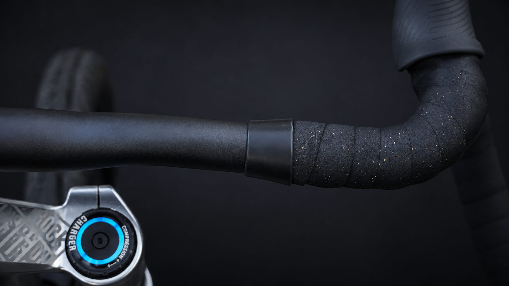 Wrap Clamp in black matte holding the end of the bar tape on a road bike drop bar