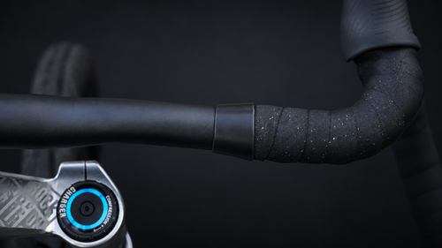 Wrap Clamp in black matte holding the end of the bar tape on a road bike drop bar