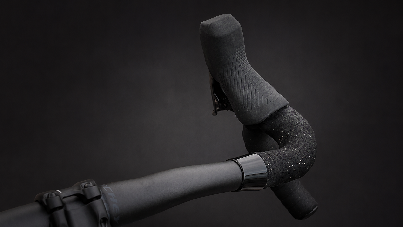 Wrap Clamp in black polished under the brake hood on a road bike drop bar